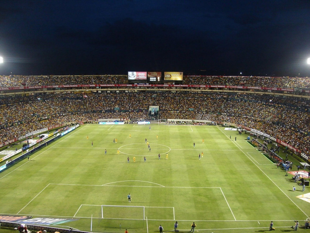 Floodlit football stadium at night